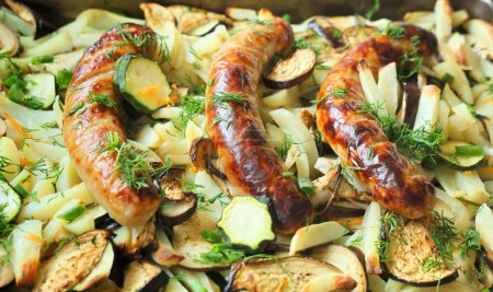 Photo for Close-up grilled in an oven vegetables with sausages, homemade food - Royalty Free Image