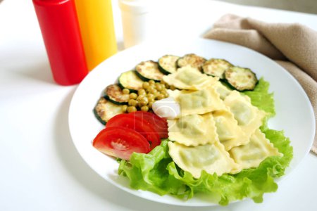 Photo for Vegan plate with delicious ravioli, vegetables and sauces - Royalty Free Image