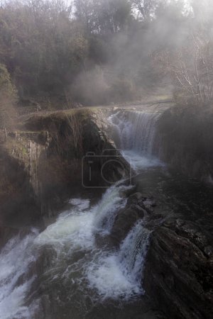 Photo for Mesmerizing display of nature: The magnificent Delika Waterfall amidst the misty mountains of Vizcaya - Royalty Free Image