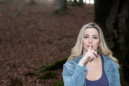 Photo for Whispering Serenity: Blonde Woman Embraces the Tranquility of an Autumn Forest - Royalty Free Image