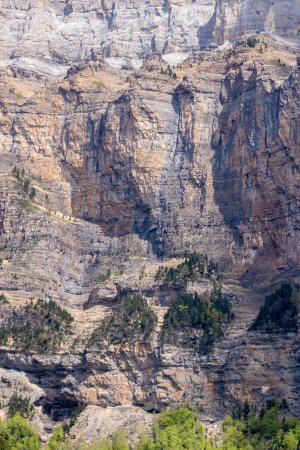 detailed rocky mountain face with layers and textures, showcasing nature's grandeur and erosion effects
