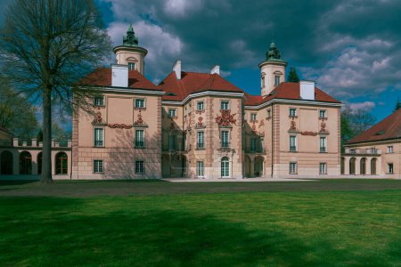 Photo for Southern facade of the Bielinsky Palace in Otwock Wielki in Poland. Classicist palace on an island on Lake Rokola, residence of a noble family - Royalty Free Image