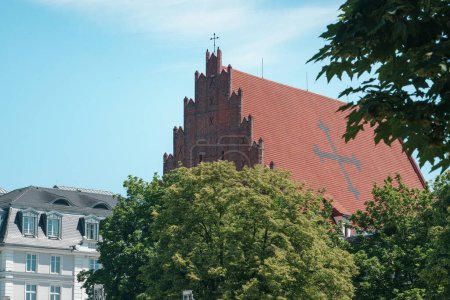 Photo for Roof of the Church of St. Stanislaus in Wroclaw. Tiled gothic roof with a cross - Royalty Free Image