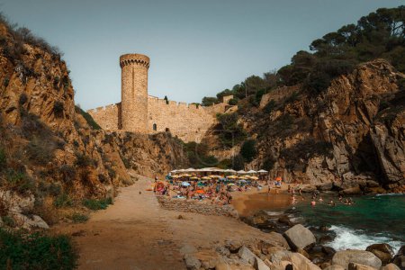 Photo for Es Codolar beach in Tossa de Mar. Fragment of the city and tower in the background - Royalty Free Image