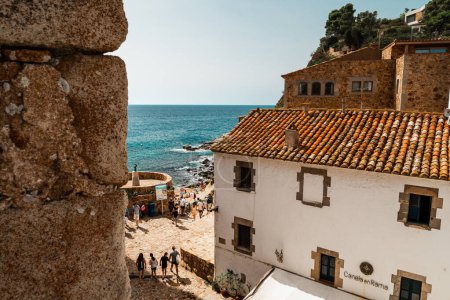 Photo for Es Codolar beach in Tossa de Mar. Fragment of the city and tower in the foreground - Royalty Free Image