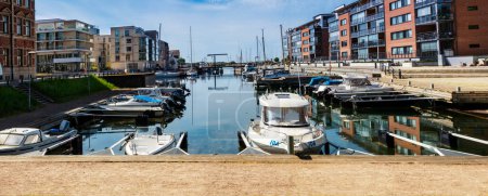 Photo for Panoramic view and water reflection in the new Nyhamn Marina in the center of Landskrona with a yacht club, Badhusgatan street, Oresund hotel. Landskrona Port. Canal, marina with yachts and fishing boats. 2023.05.19 - Royalty Free Image