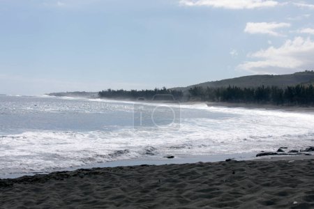 A photo of beach with black sand in La Reunion