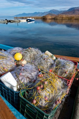 Fishing nets in a traditional wooden fishing boat at the Mikri Prespa lake, Greece