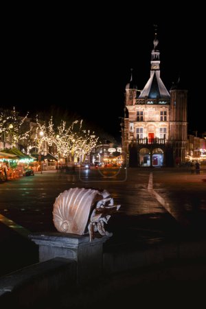 City scenic at night with illuminated streets, and monumental buildings in the Dutch village Deventer in the Netherlands