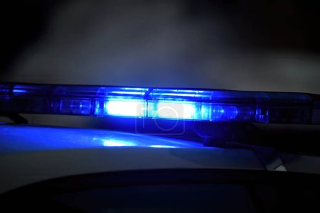 Photo for Police car with blue light on the street at night, selective focus - Royalty Free Image