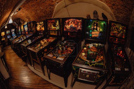 Photo for Krakow, Poland - November 17, 2023: A collection of pinball machines in an underground bar - Royalty Free Image