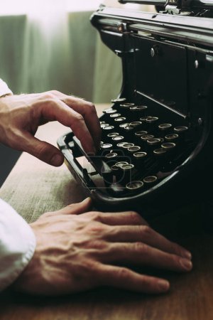 A writer writing a novel, using old vintage typewriter