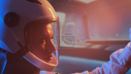 Photo for A woman astronaut in a space suit aboard the orbital station. A young female cosmonaut pilots a spaceship. The concept of galactic travel and science. - Royalty Free Image