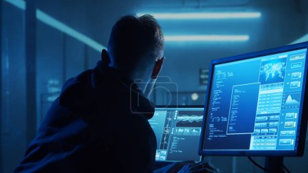 Computer Hacker in Hoodie. Obscured Dark Face. Hacker Attack, Virus Infected Software, Dark Web and Cyber Security concept.