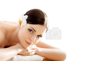 Photo for Beautiful and healthy brunette woman is getting massage treatment in spa salon. The concept of spa, health and healing. - Royalty Free Image