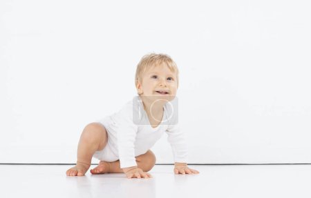 Photo for Little, happy and smiling cute baby in the studio. Portrait of a one year old baby. Isolated white background. The concept of happiness. - Royalty Free Image