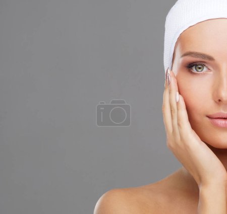 Photo for Beautiful face of young and healthy girl over grey background. Skin care, cosmetics and face lifting concept. - Royalty Free Image