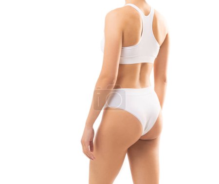 Photo for Young and beautiful slender girl in white swimsuit posing over white background. The concept of healthcare, diet, sport and fitness. - Royalty Free Image