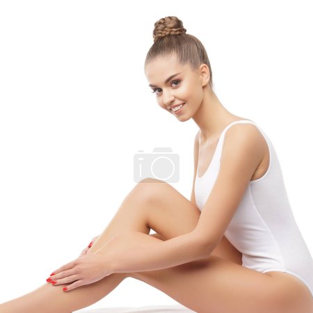 Photo for Young, fit and beautiful brunette woman in white swimsuit posing over white background. Healthcare, diet, sport and fitness concept. - Royalty Free Image