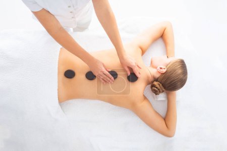 Photo for Young woman getting massaging treatment over white background. Spa, healthcare and recreation concept. - Royalty Free Image