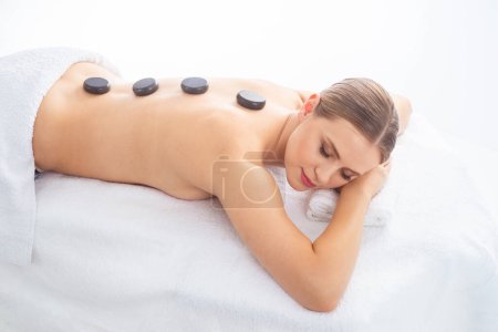 Photo for Young woman getting massaging treatment over white background. Spa, healthcare and recreation concept. - Royalty Free Image