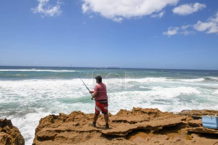 Photo for Mission Rocks, South Africa - 14 January 2023: people fishing at Mission Rocks on Isimangaliso park in South Africa - Royalty Free Image