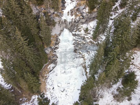 Drone view at a frozen waterfall at Engelberg on the Swiss alps