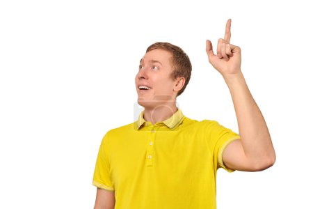 Photo for Smiling young guy in yellow T-shirt with eureka gesture, man got idea isolated on white background. Surprised man pointing index finger up, found solution to work task, remembered forgotten thought - Royalty Free Image