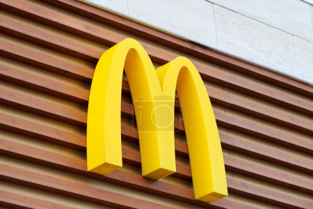 Photo for Rostov on Don, Russia - 02.21.2022 - McDonalds logo on restaurant branch, yellow macdonald logo of popular fast food company. Mac donald brand logotype above entrance to cafe - Royalty Free Image