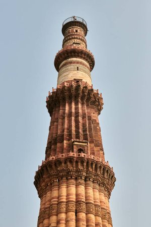 Qutb Minar minaret tower part Qutb complex in South Delhi, India, big red sandstone minaret tower landmark popular touristic spot in New Delhi, ancient indian architecture of tallest brick minaret