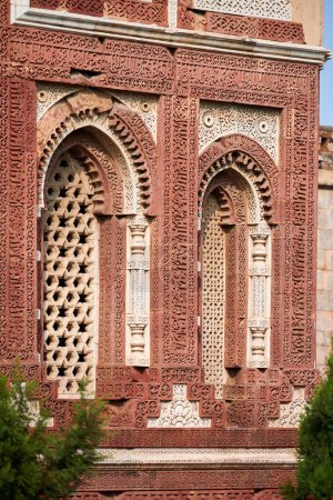 Photo for Decorative window shutters of Alai Darwaza landmark part of Qutb complex in South Delhi, India, red sandstone and inlaid white marble ancient window decorations of Alai Darwaza main gateway - Royalty Free Image