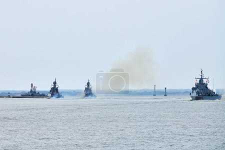 Flotilla of Russian warships sailing toward military target, armed warships ready for attack enemy performing strategic maneuver, Russian sea power deployment warships for tactical advantage