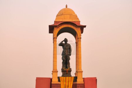 Statue of Subhas Chandra Bose under canopy behind India Gate war memorial, monolithic Netaji statue made of black granite in New Delhi immortalizes Indian freedom fighter of Indian National Army