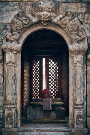 Ancient votive shrine of Pandra Shivalaya with Shiva Lingam in Pashupatinath Temple in Kathmandu, Nepal, religious symbol in Hinduism emanates sacred aura and divine energy