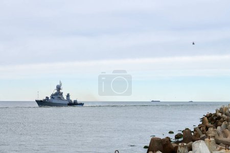 Photo for Russian warship armed with armament sails into sea toward military target to attack and destroy enemy, military ship performing strategic maneuver, Russian sea power deployment for tactical advantage - Royalty Free Image