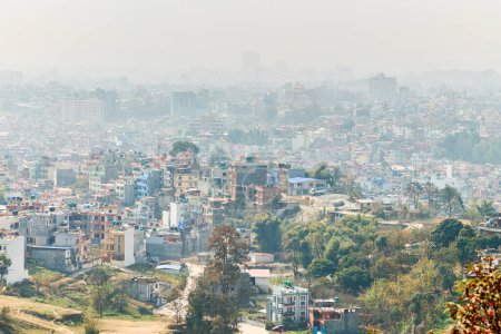 View of Kathmandu capital of Nepal from mountain through urban haze with lot of low rise buildings, cityscape creating an ethereal atmosphere in mountain air, Kathmandu air pollution