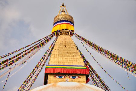 Boudhanath stupa in Kathmandu, Nepal decorated Buddha wisdom eyes and prayer flags, most popular tourist attractions in Kathmandu reflecting harmonious blend of spirituality and tourism