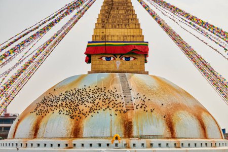 Boudhanath stupa in Kathmandu, Nepal decorated Buddha wisdom eyes and prayer flags, most popular tourist attractions in Kathmandu reflecting harmonious blend of spirituality and tourism