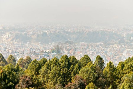 View of Kathmandu capital of Nepal from mountain through urban haze with lot of low rise buildings, cityscape creating an ethereal atmosphere in mountain air, Kathmandu air pollution