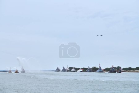 Photo for Military fighter jets are flying over Russian naval forces parade warships along coastline, seafaring tradition of military ships formation at Navy Day, nautical spectacle of russian sea power - Royalty Free Image