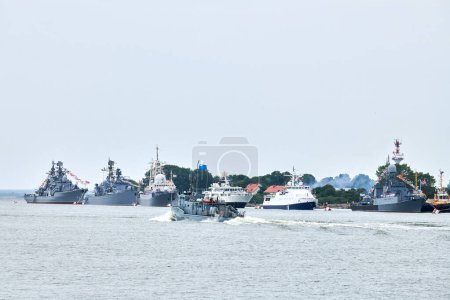 Photo for Military warship sailing along Russian naval forces parade warships along coastline, seafaring tradition of military ships formation along shore, nautical spectacle of russian sea power - Royalty Free Image
