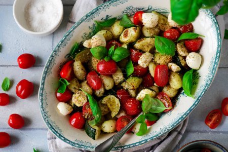 Photo for Italian Caprese salad with gnocchi and vegetables.. style vintage.selective focus - Royalty Free Image
