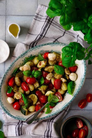 Photo for Italian Caprese salad with gnocchi and vegetables.. style vintage.selective focus - Royalty Free Image
