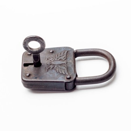 Eustic padlock, adorned with an eagle emblem, paired with its key. The lock aged appearance and detailed design evoke a sense of history and security.
