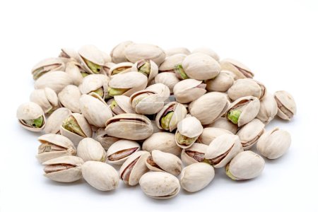 heap of natural pistachios on a white background