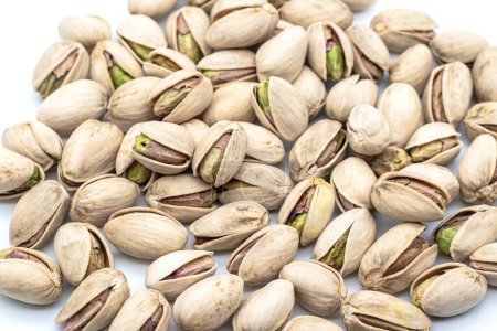 Photo for Heap of natural pistachios on a white background - Royalty Free Image