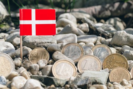 Photo for Danish flag with euro coins amid,gravel surface,currency exchange,business,finance and economy concept,macro close-up - Royalty Free Image