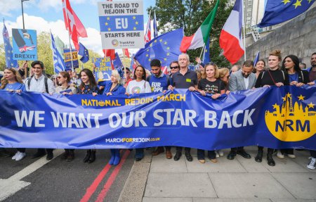 Photo for London, UK. 23rd September 2023. Pro-EU supporters holding the lead banner sign at the anti-Brexit National Rejoin March rally in London, calling for the United Kingdom to rejoin the European Union. - Royalty Free Image