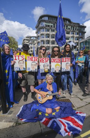 Photo for London, UK. 23rd September 2023. Pro-EU supporters holding protest signs at the anti-Brexit National Rejoin March rally in London, calling for the United Kingdom to rejoin the European Union. - Royalty Free Image