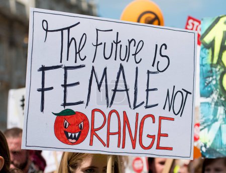 Photo for London, UK. 13th July 2018. One of the many hundreds of posters and placards, seen at the #BringTheNoise Women's March Anti Donald Trump protest demonstration through the streets of central London, UK. - Royalty Free Image